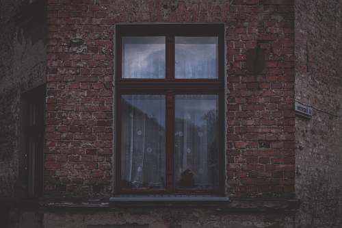 window brown framed glass windowpane brick