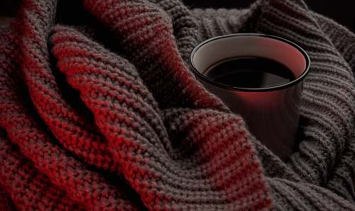winter white cup on beige knitted cloth red