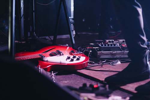 music red electric guitar on flooring electric guitar