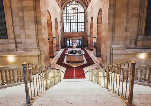 banister red carpet surrounds the reception desk aisle