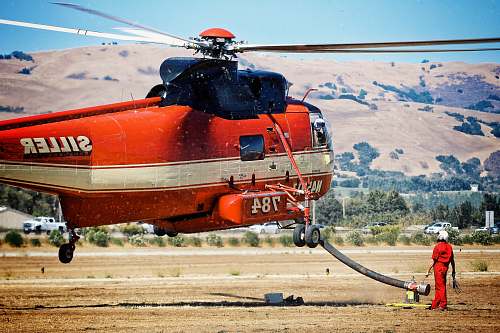 transportation red and white Siller chopper ascending aircraft