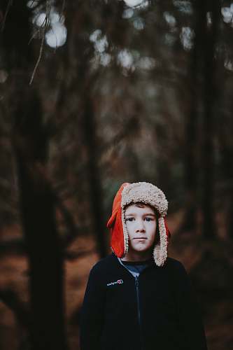 people boy wearing red ear pluff person