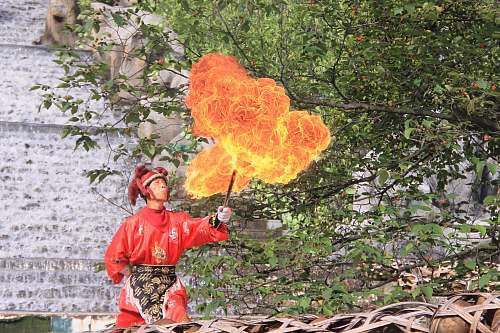 people man doing fire activity during daytime person