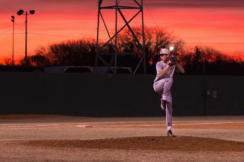 people man pitching baseball during sunset person