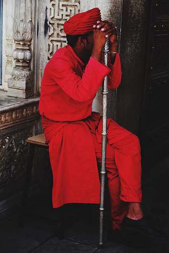 clothing man sitting on stool holding walking cane apparel