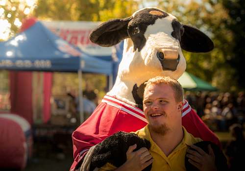 person men near cow mascot  cow