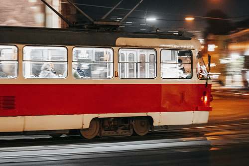 person people inside white and red bus during night time train