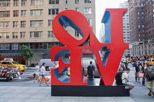 person people surrounding LOVE text statue building