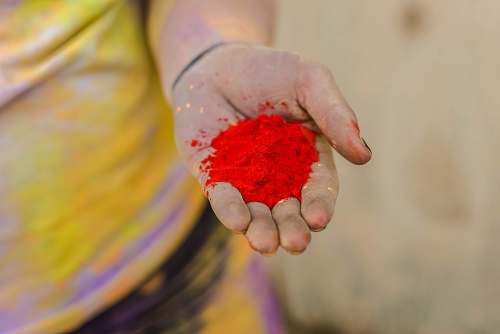 person person holding red powder finger