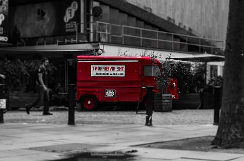 person selective color photo of red van vehicle