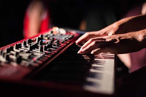 person selective focus photo of person playing electric guitar music