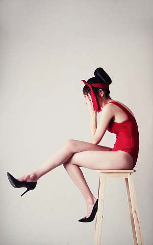 people upset woman sitting on stool with white background person