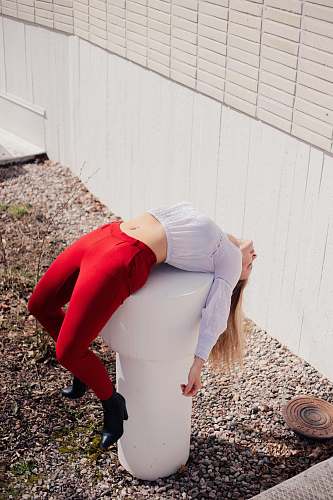 clothing woman bending on white hydrant apparel