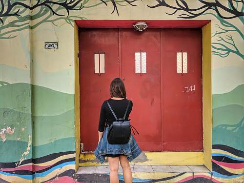 person woman facing wooden door people