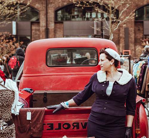 people woman holding red Chevrolet pickup truck during daytime person