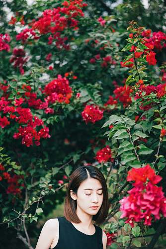 person woman in black top closing her eyes people