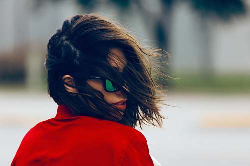 people woman wearing red top and black sunglasses at daytime woman