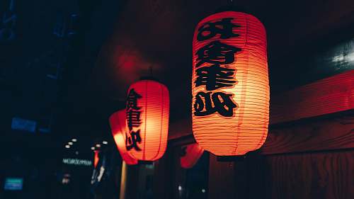 lamp close-up photography of two orange paper lanterns with kanji script asian
