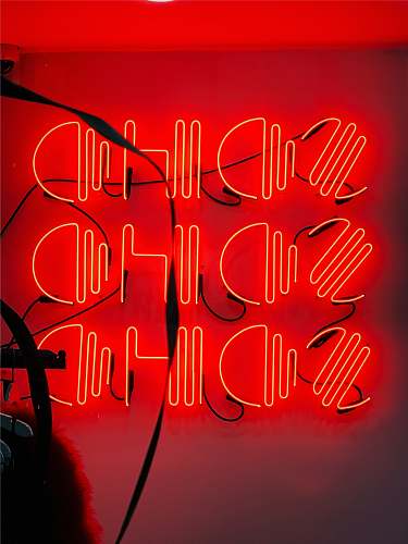 neon red neon signage on wall advertisement