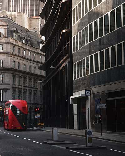 bus red bus in front of black painted building transportation