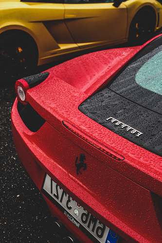 spoke red Ferrari sports car with licence plate number 6M63127 wheel
