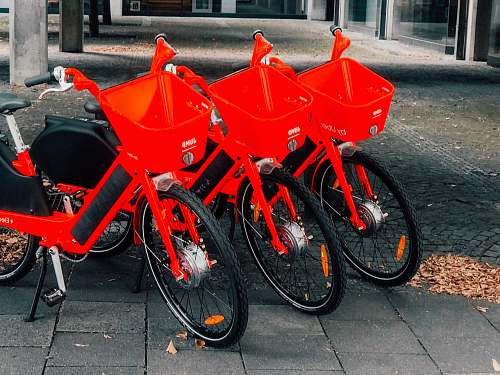 wheel three bicycles parked near post bicycle