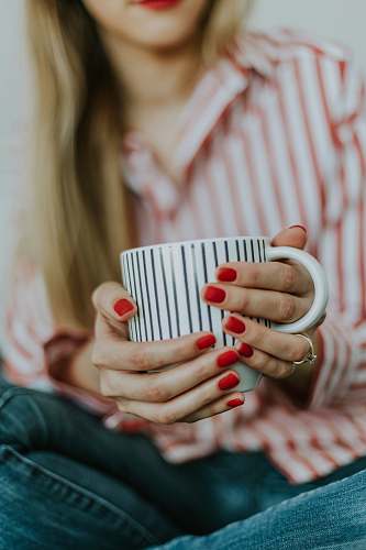 riga selective focus photo of a woman holding a white coffee mug latvia