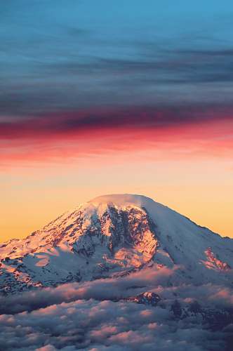sunrise mountain covered in snow at daytime sunset
