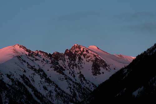 outdoors mountain covered in snow at golden hour mountain range