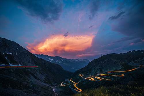 sky timelapse photo of zigzag road during nighttime switzerland