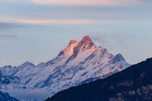 peak white and black mountains covered by snow under blue sky at daytime switzerland
