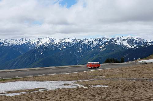 alps yellow Type B motorhome on road near mountain under cumulus nature