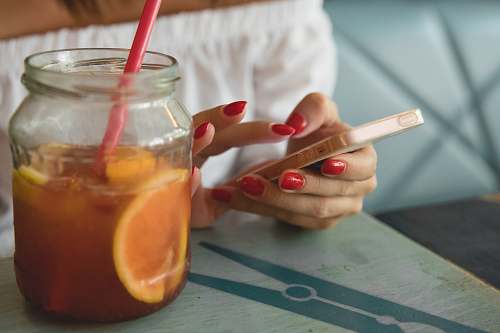 manicure clear glass jar filled with fruit juice drink