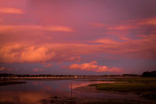 outdoors body of water under clouded sky during golden hour land