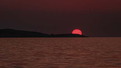 outdoors body of water viewing mountain during sunset sun