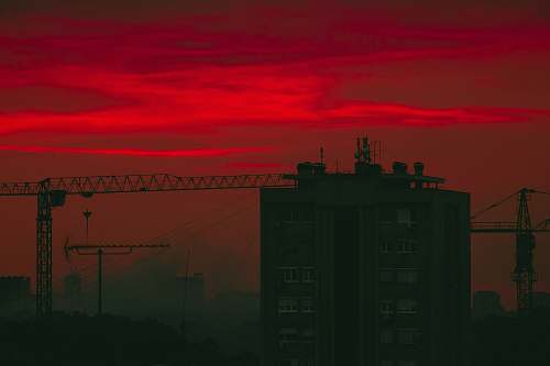 outdoors brown building under red clouds dawn