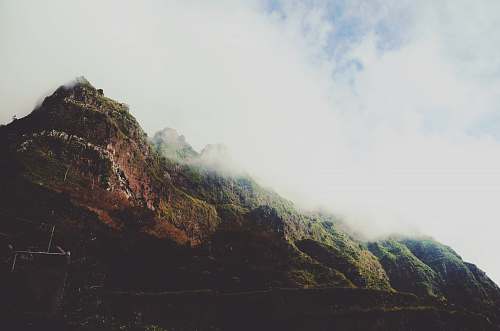 mountain mountain covered with clouds cliff