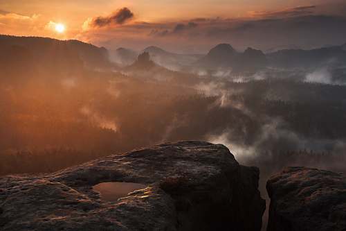 dawn photograph of mountains surrounded by mist mountain