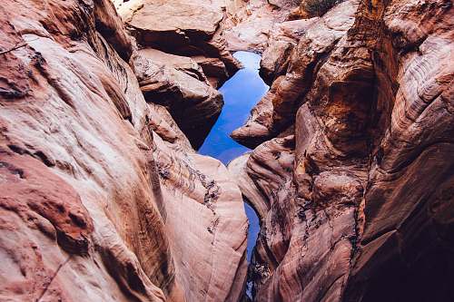 rocks rocky mountain near body of water canyon