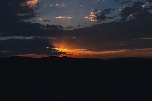 sunset silhouette of mountains sky