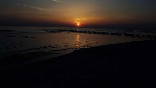 outdoors wavy seashore during golden hour sunset