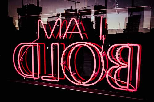 sign I Am bold neon signage at night time words