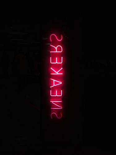 paris turned on red sneakers neon light in dark place france