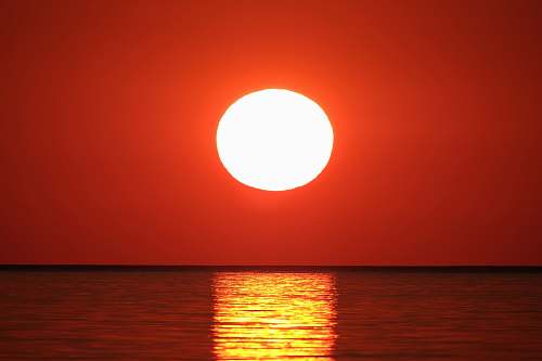 nature sunset over body of water sun