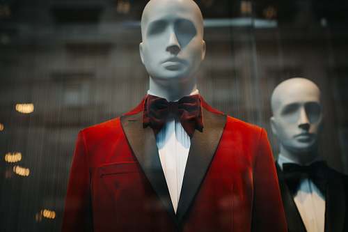 person mannequin wearing red notched lapel suit jacket human