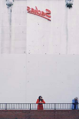 human woman in handrail under Sachas signage person
