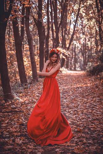 person woman in red dress surrounded by trees human