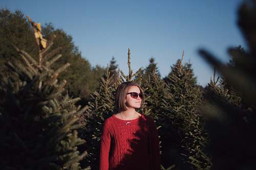person woman standing surrounded by green trees human