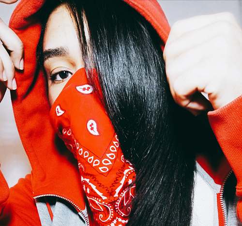 human woman wearing red and white paisley scarf taking close-up selfie person