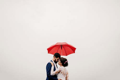 red man and woman under red umbrella human